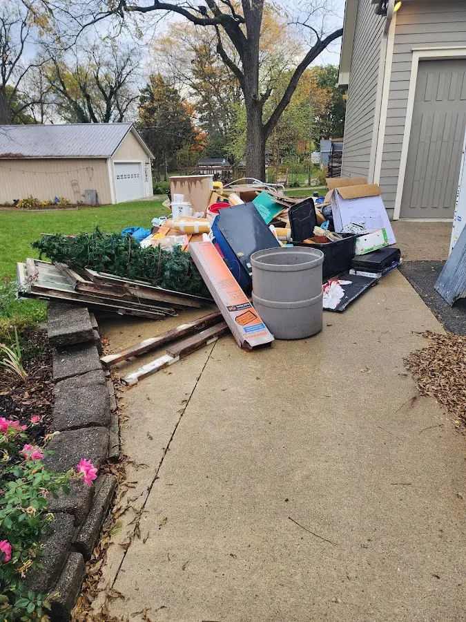 Dumpster being loaded with debris for Residential Dumpster Rental in Portage